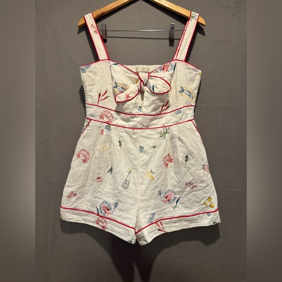 Caroline Constas Cream Romper with Red Trim and Adorable Embroidery.
